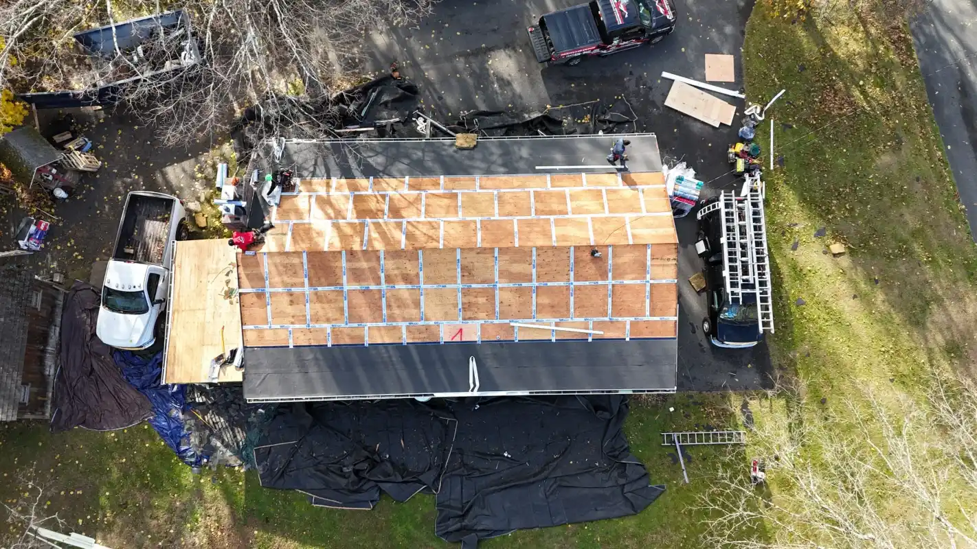 Aerial view of a house under construction with new roof sheathing