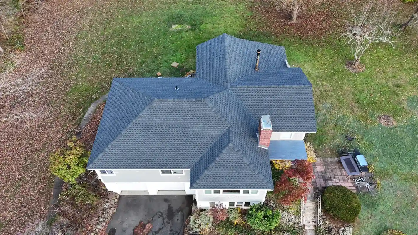 Aerial view of a house with a new grey shingled roof
